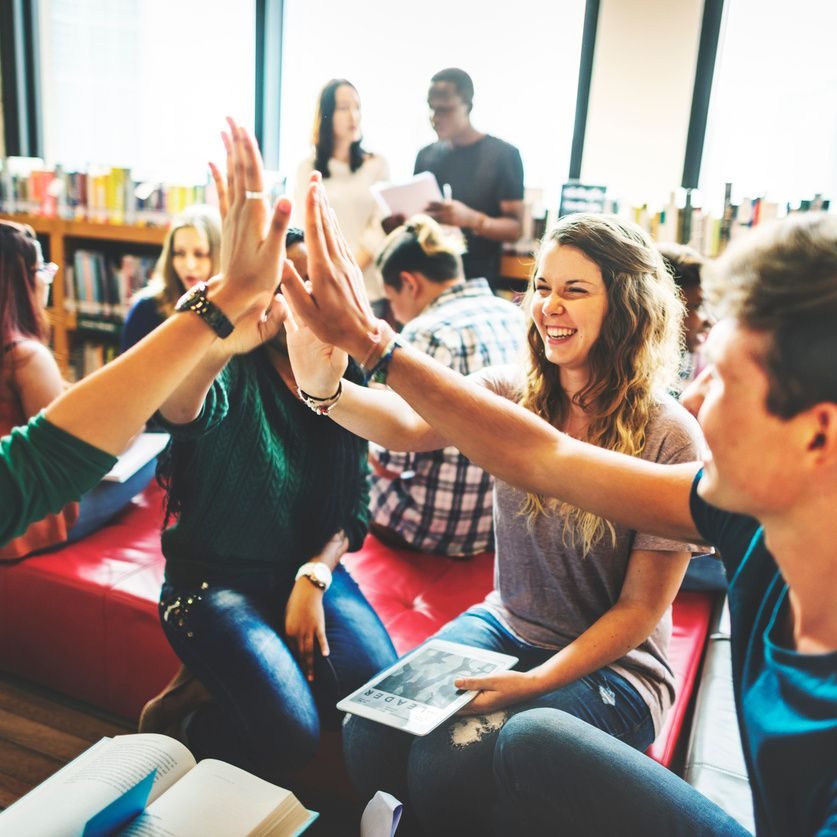 stock image of students gathered in a library